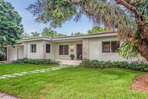 An Ancient Giant Oak tree frames the handsome front of this South Gables home